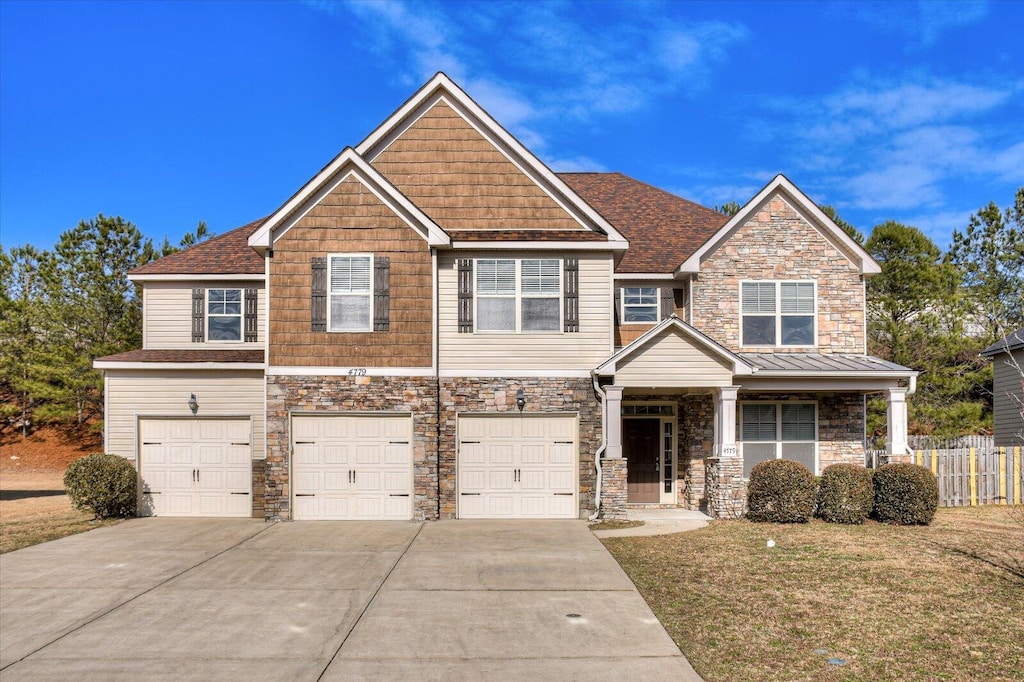 craftsman-style house with a garage and a front yard