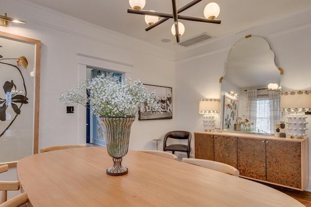 dining space with crown molding and visible vents