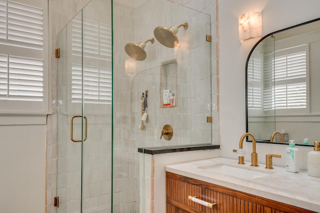 bathroom with vanity and a shower stall