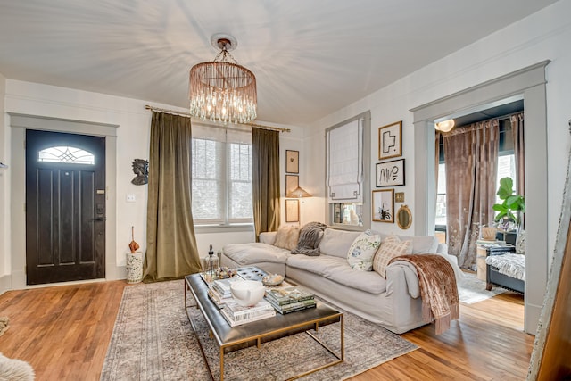 living area featuring light wood-style floors and an inviting chandelier