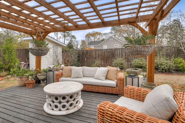 deck with an outdoor hangout area, a pergola, and a fenced backyard