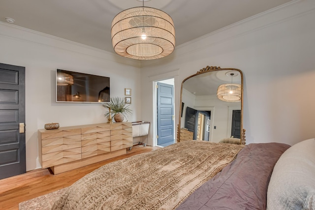 bedroom featuring crown molding and wood finished floors