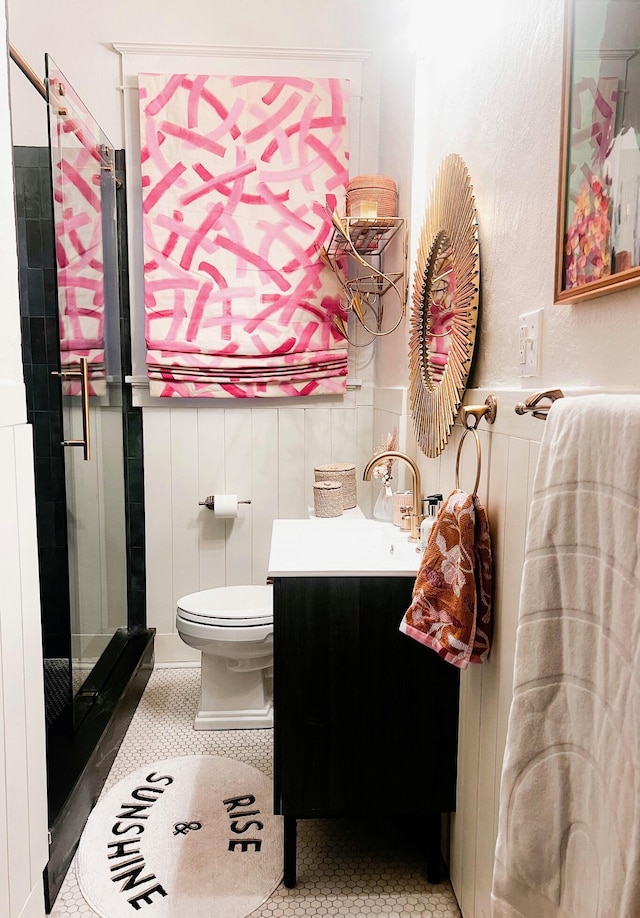 full bathroom featuring vanity, toilet, a stall shower, and tile patterned flooring