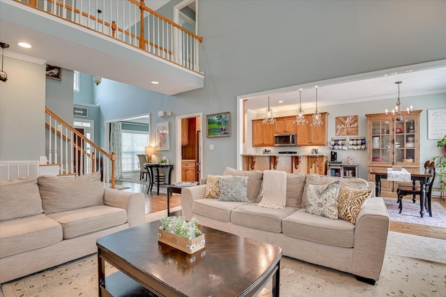 1076 Conn Dr, Evans, GA 30809 - living area featuring a high ceiling, stairway, a chandelier, crown molding, and recessed lighting