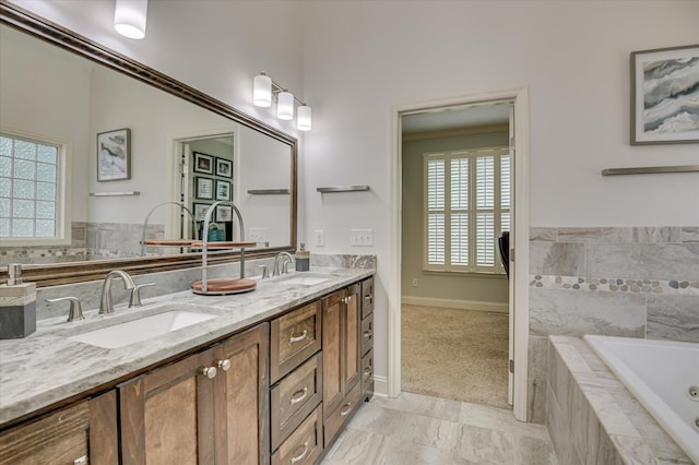 1076 Conn Dr, Evans, GA 30809 - bathroom featuring double vanity, a tub with jets, baseboards, and marble finish flooring