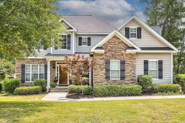 1076 Conn Dr, Evans, GA 30809 - view of front of home with stone siding, a front lawn, and a shingled roof
