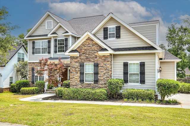 1076 Conn Dr, Evans, GA 30809 - view of front of home featuring stone siding, roof with shingles, and a front yard