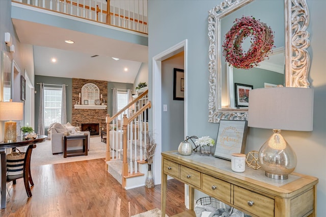 1076 Conn Dr, Evans, GA 30809 - entrance foyer with wood finished floors, a stone fireplace, stairs, and baseboards