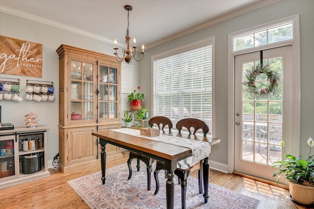 1076 Conn Dr, Evans, GA 30809 - dining space with a chandelier, light wood finished floors, crown molding, and baseboards