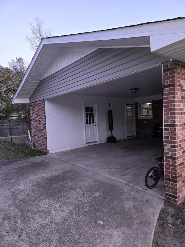 exterior space featuring driveway and fence