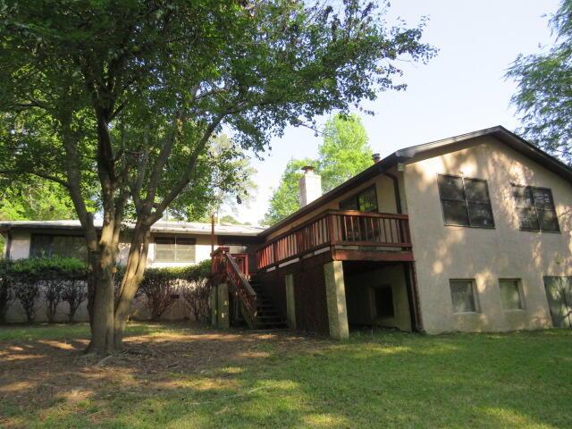 4629 Silver Lake Dr, Evans, GA 30809 - rear view of house featuring stairway, a chimney, a yard, stucco siding, and a wooden deck