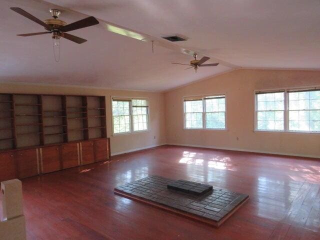 4629 Silver Lake Dr, Evans, GA 30809 - unfurnished living room with ceiling fan, vaulted ceiling, wood finished floors, and baseboards