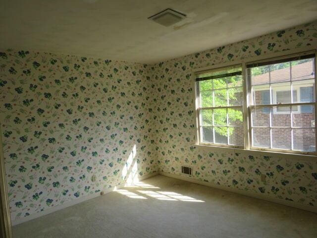 4629 Silver Lake Dr, Evans, GA 30809 - carpeted empty room with wallpapered walls, baseboards, and visible vents