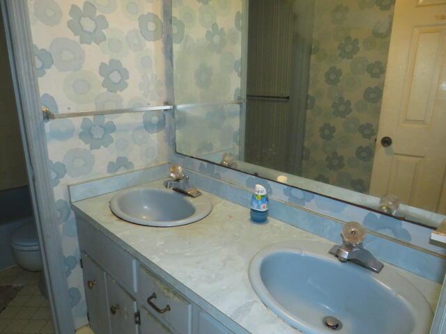 4629 Silver Lake Dr, Evans, GA 30809 - bathroom with wallpapered walls, a sink, and toilet