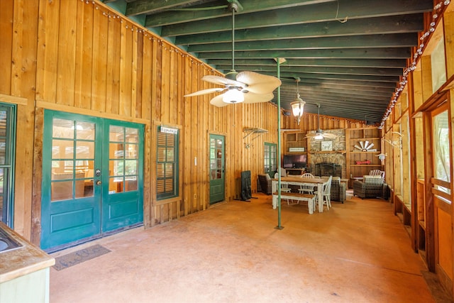 interior space featuring french doors, a fireplace, and lofted ceiling