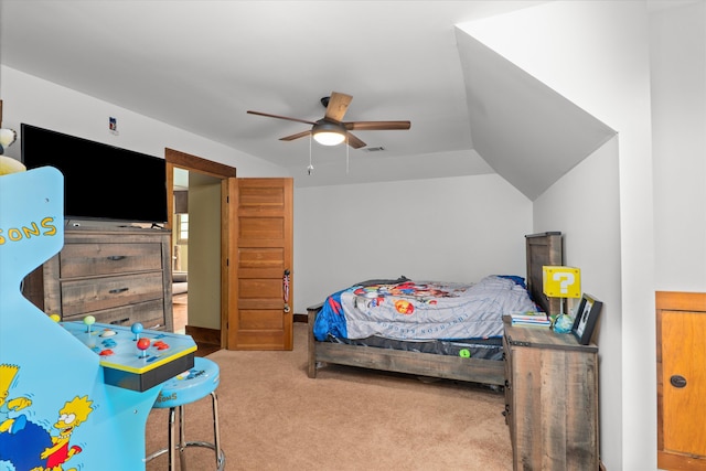 bedroom with ceiling fan, lofted ceiling, and light carpet