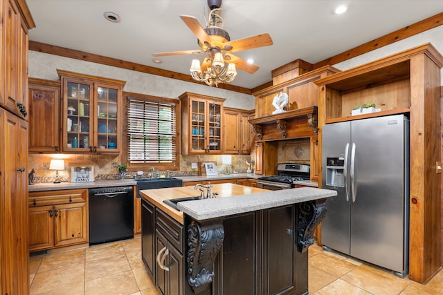 kitchen featuring ceiling fan, sink, a center island with sink, light tile patterned flooring, and appliances with stainless steel finishes