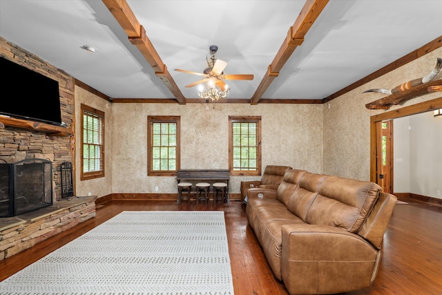 living room with a stone fireplace, ceiling fan, hardwood / wood-style floors, and beamed ceiling