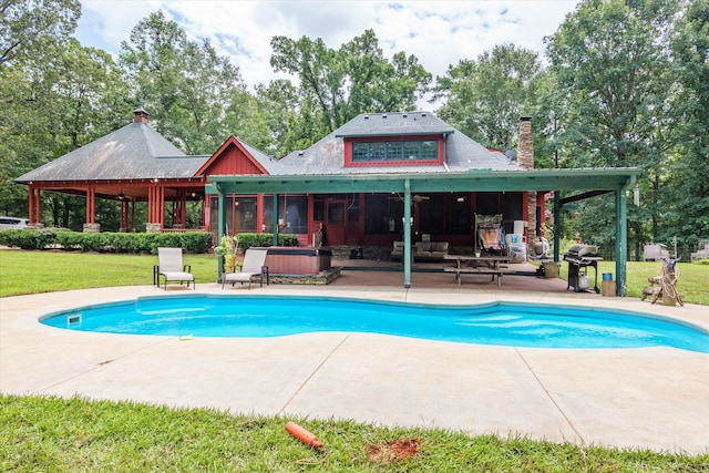 view of swimming pool featuring area for grilling, a patio, a hot tub, and a yard