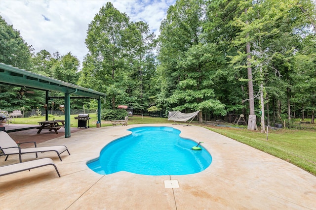 view of swimming pool featuring a yard, area for grilling, and a patio area