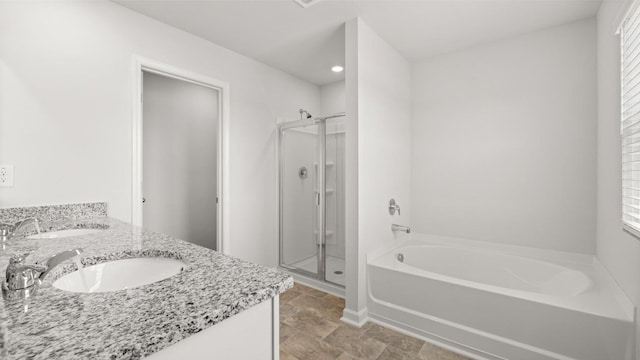 bathroom with vanity and shower with separate bathtub