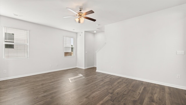 empty room with dark hardwood / wood-style flooring and ceiling fan