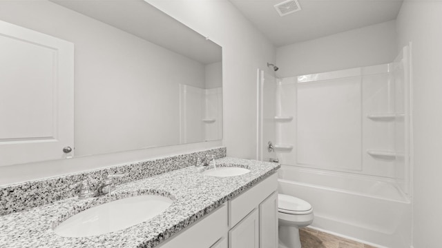 full bathroom featuring shower / tub combination, vanity, and toilet