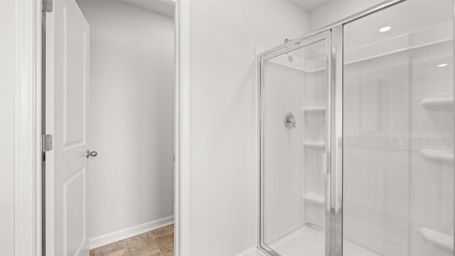 bathroom with a shower with door