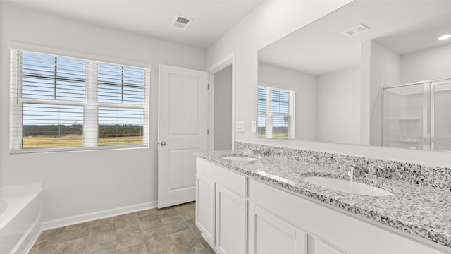 bathroom with vanity and shower with separate bathtub