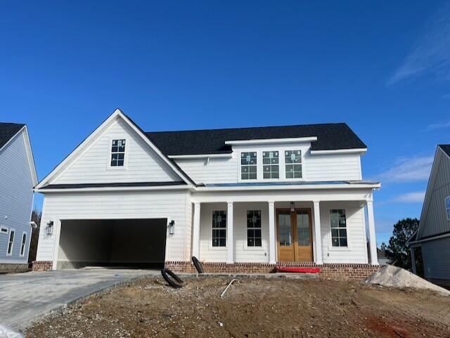 view of front facade featuring a garage and covered porch