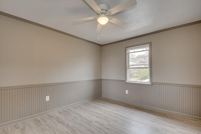 spare room featuring ceiling fan, light hardwood / wood-style floors, a textured ceiling, and ornamental molding