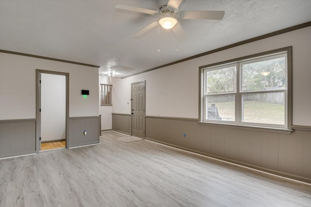 unfurnished bedroom with ceiling fan, light hardwood / wood-style floors, crown molding, and a textured ceiling