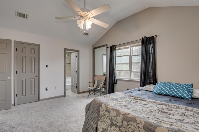 carpeted bedroom with ceiling fan, ensuite bathroom, and vaulted ceiling