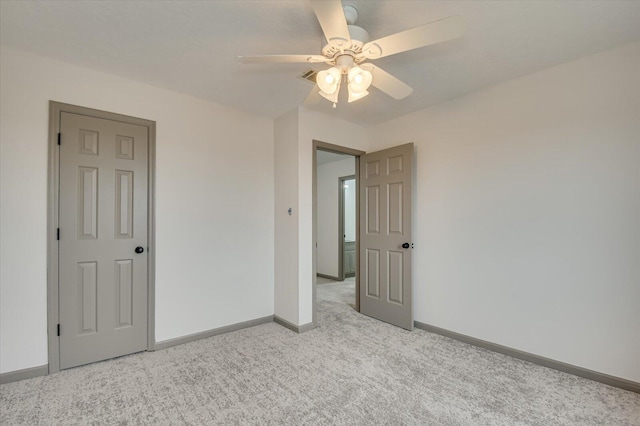 unfurnished bedroom featuring ceiling fan and light carpet