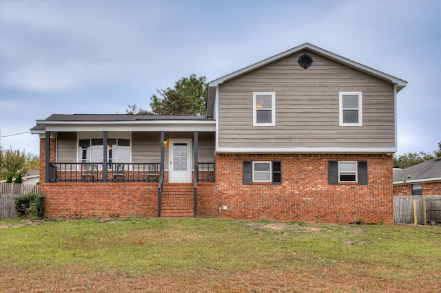 tri-level home with covered porch and a front yard