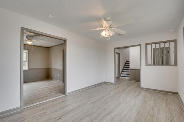 spare room with light hardwood / wood-style floors and ceiling fan