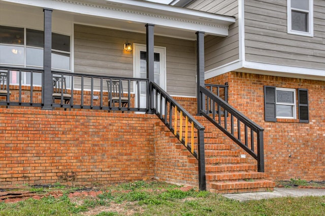 view of exterior entry featuring covered porch