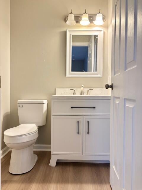 2060 Morning Dr, Augusta, GA 30906 - half bathroom featuring vanity, baseboards, toilet, and wood finished floors