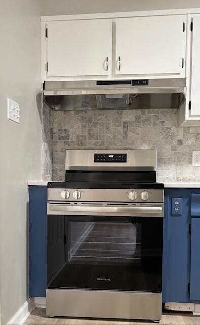 2060 Morning Dr, Augusta, GA 30906 - kitchen featuring stainless steel electric range, blue cabinetry, baseboards, under cabinet range hood, and backsplash