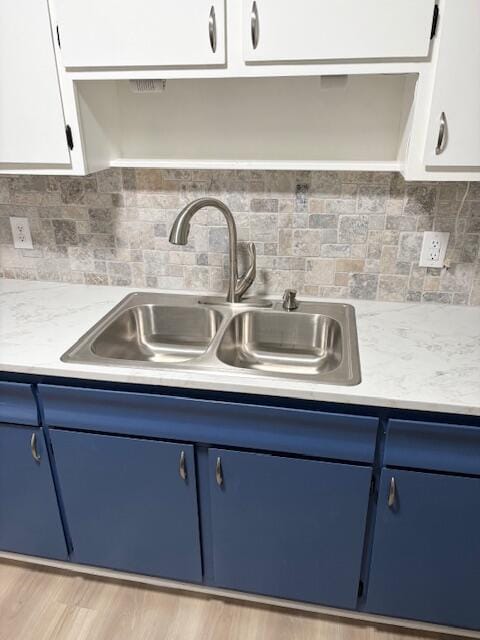 2060 Morning Dr, Augusta, GA 30906 - kitchen with blue cabinetry, a sink, light countertops, and backsplash