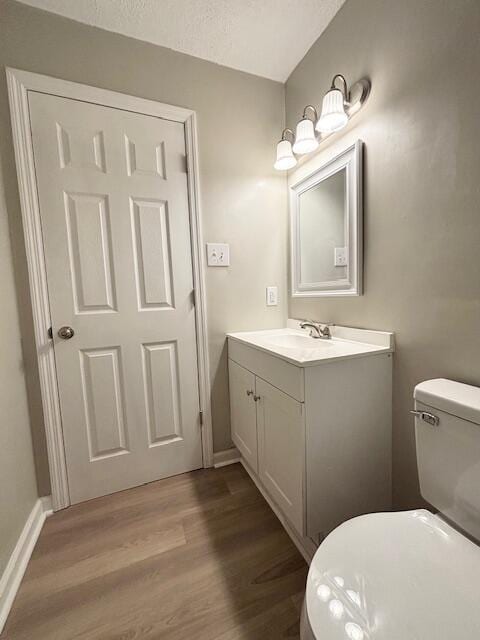 2060 Morning Dr, Augusta, GA 30906 - half bathroom with vanity, wood finished floors, toilet, and baseboards