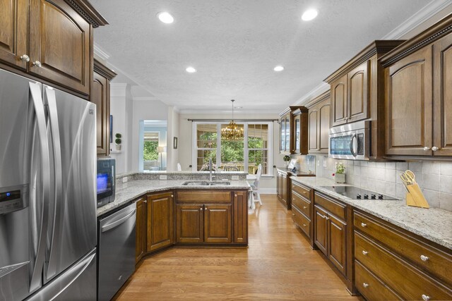 108 Pine Needle Rd, Aiken, SC 29803 - kitchen featuring stainless steel appliances, crown molding, light wood-type flooring, light stone countertops, and recessed lighting
