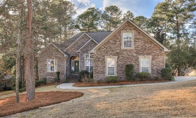 108 Pine Needle Rd, Aiken, SC 29803 - traditional-style house with a front yard and brick siding