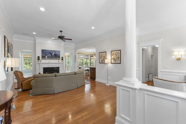 108 Pine Needle Rd, Aiken, SC 29803 - living room featuring decorative columns, ornamental molding, a ceiling fan, a fireplace, and wood finished floors