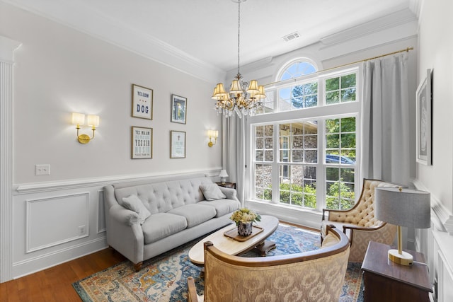108 Pine Needle Rd, Aiken, SC 29803 - living area with healthy amount of natural light, wood finished floors, crown molding, a chandelier, and a wainscoted wall