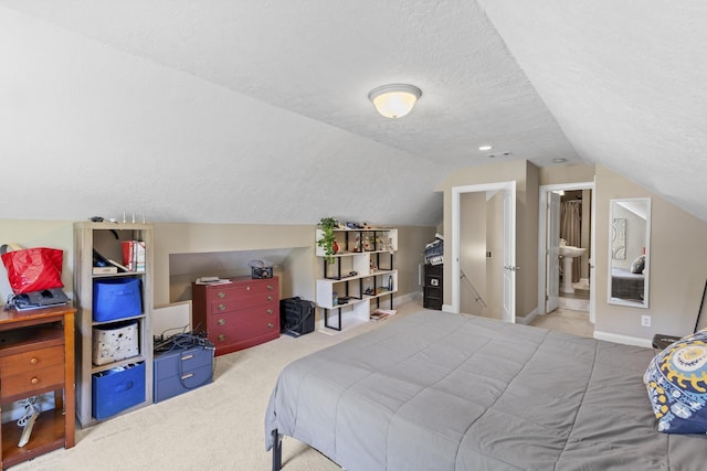108 Pine Needle Rd, Aiken, SC 29803 - carpeted bedroom featuring a textured ceiling, vaulted ceiling, baseboards, and ensuite bathroom