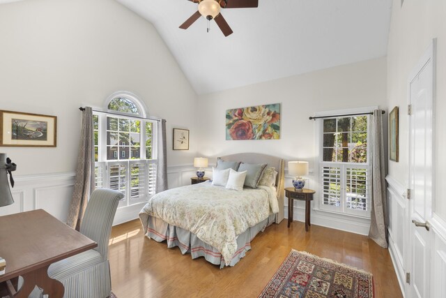 108 Pine Needle Rd, Aiken, SC 29803 - bedroom featuring multiple windows, high vaulted ceiling, a decorative wall, a wainscoted wall, and wood finished floors