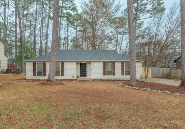 ranch-style home with cooling unit and a front lawn