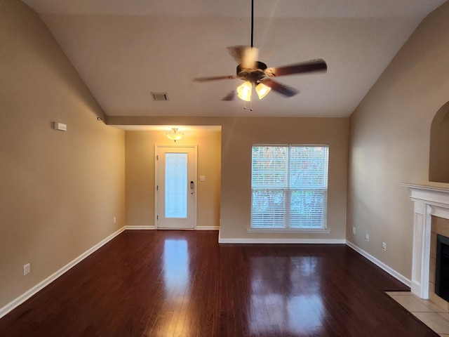 unfurnished living room with ceiling fan, lofted ceiling, hardwood / wood-style floors, and a tile fireplace