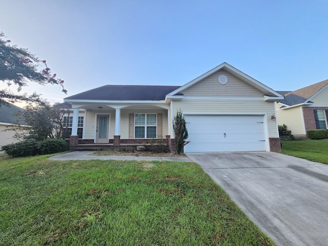 ranch-style house with a garage, a front lawn, and covered porch